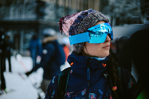 Portrait of a female skier wearing protective goggles.