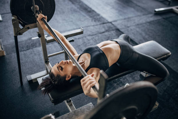 istock Young woman training on bench press 1383489869