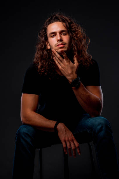 Portrait of a handsome stylish man posing in trendy modern clothing