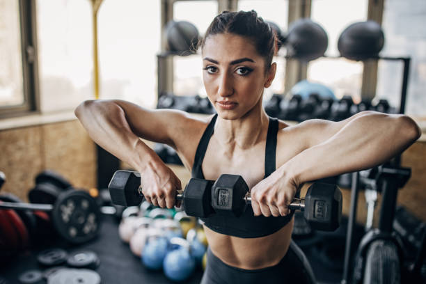 istock Woman training with dumbbells 1383490819
