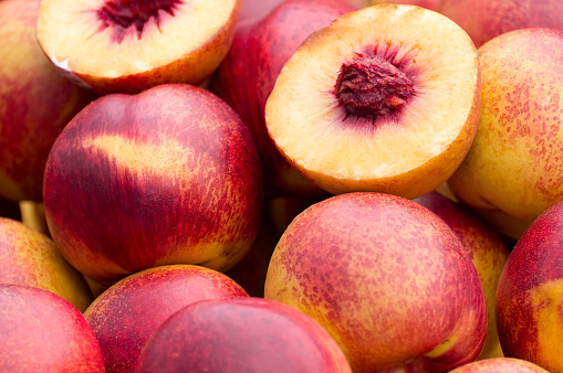 View of a pile of fresh and juicy peaches in a farmer's market.