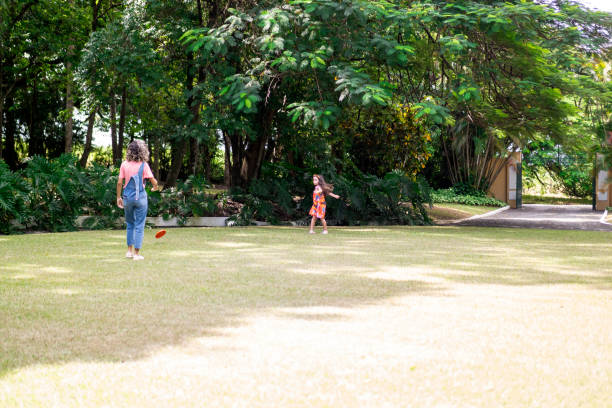 istock Kids playing frisbee in the grass 1383493373