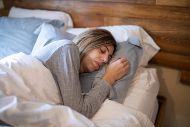 istock Woman sleeping in bed 1383495369