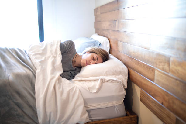 istock Woman sleeping in bed 1383495441