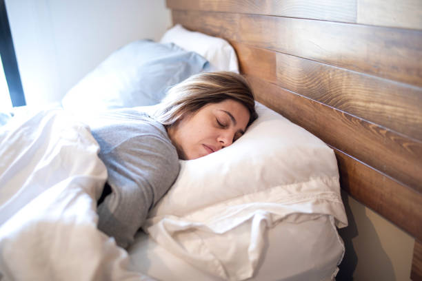 istock Woman sleeping in bed 1383495465
