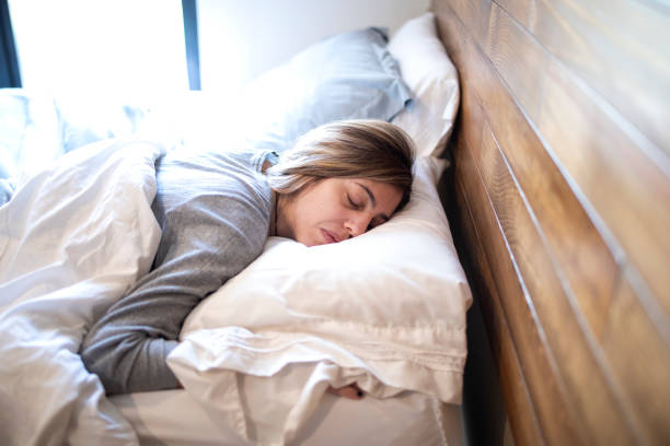 istock Woman sleeping in bed 1383495466