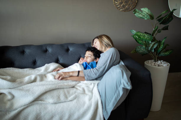 istock Mother and child sleeping on the couch 1383495576