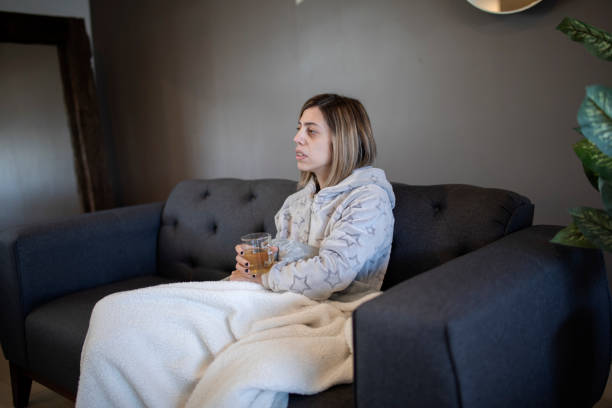 istock Woman drinking tea on the sofa 1383496952