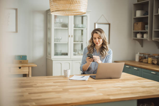 istock Woman  manage household finances in kitchen 1383497661