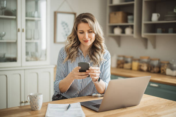 istock Woman  manage household finances in kitchen 1383497666