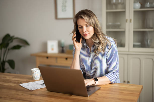 istock Woman  manage household finances in kitchen 1383497697