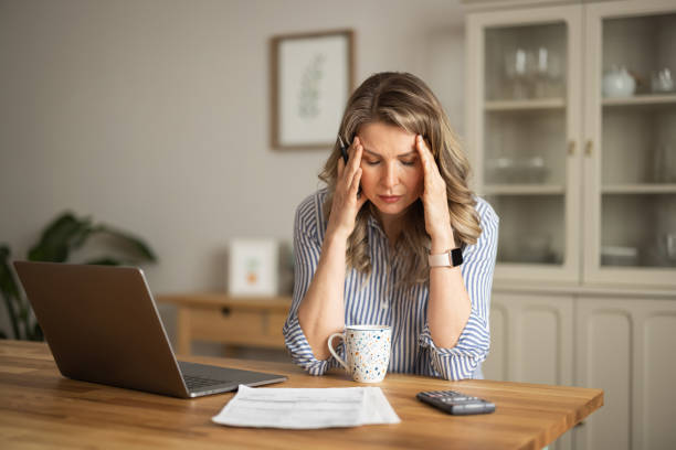 istock Woman  manage household finances in kitchen 1383498240