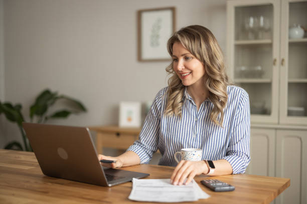 istock Woman  manage household finances in kitchen 1383498257