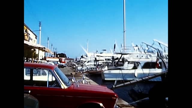 car at the port with boats Argentario from the 70s