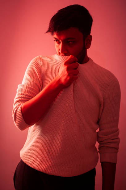 istock fashion model posing in red color gel light in studio 1383500024