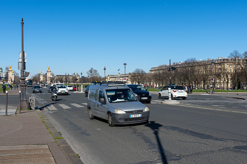 White electric taxi on Westminster Bridge in London with Big Ben and Westminster Palace in the background