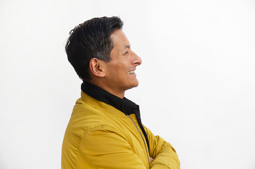 A mid forties man, photographed in profile against a white background