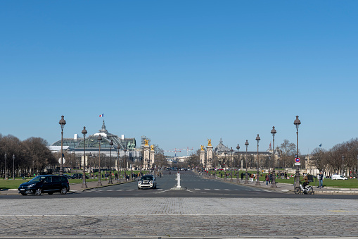 Paris, France-02 13 2024: People and cars on Place de la Concorde in front of the Hotel de la Marine, Paris, France.