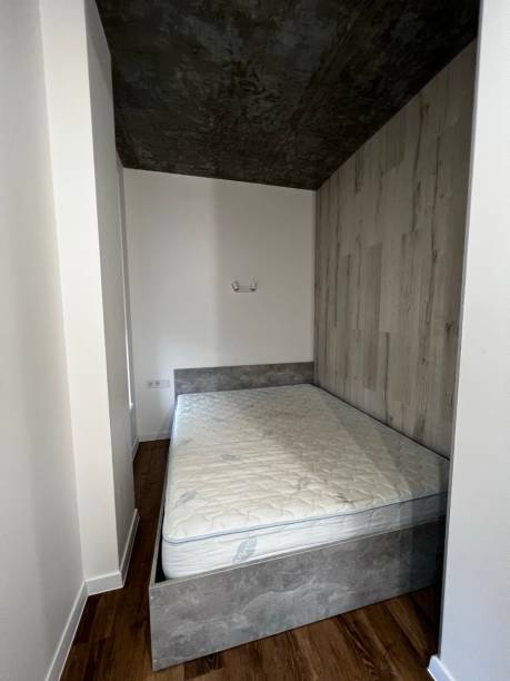 istock Small bedroom with new grey bed 1383501439