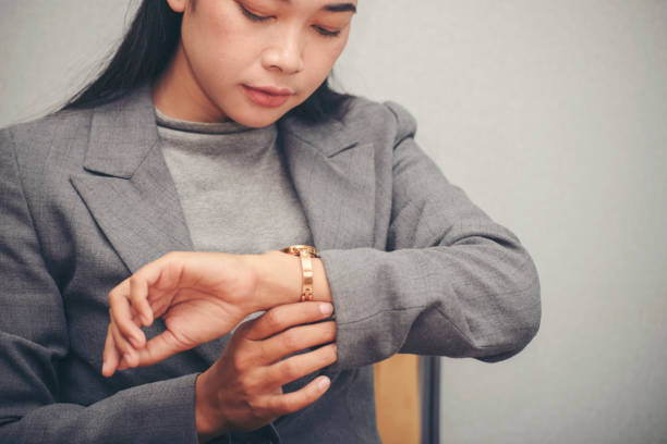 istock Time out concept. Urgent work, business woman seeing wrist watch and using mobile phone before meeting. Smart woman check the schedule before going to the office. Time out for appointment meeting. 1383501741