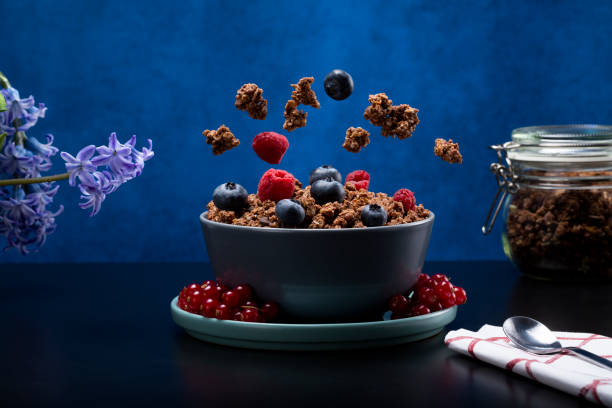 istock Granola cereal and fruit falling into a bowl 1383501750