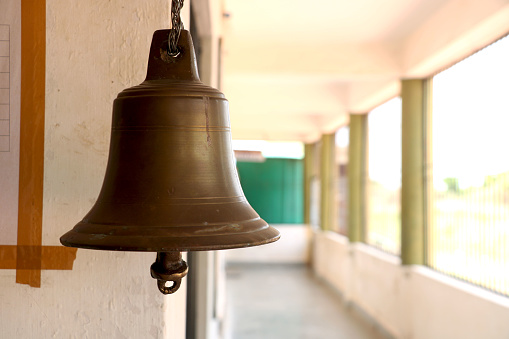 portrait view of bell hanging in school building