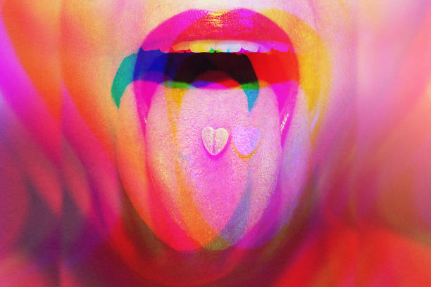 Woman with psychoactive drug pills on her tongue having psychedelic trip with hallucinations Young woman with colorful psychoactive drug pills on her tongue having psychedelic trip with hallucinations lsd trip stock pictures, royalty-free photos & images