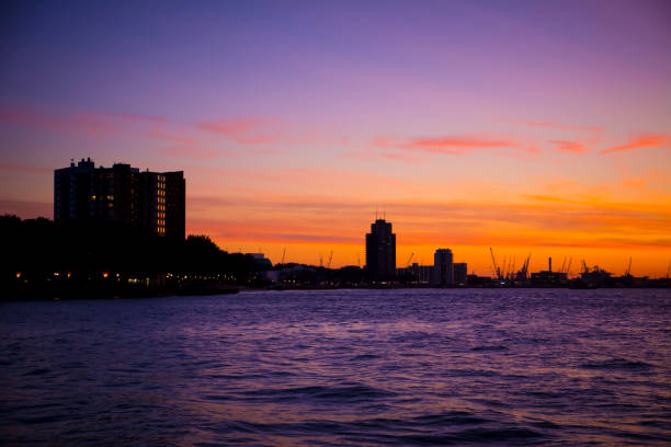 istock Rotterdam harbor silhouette during sunset with cranes in the distance 1383503904