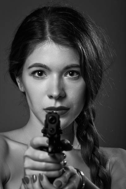 istock woman with gun 1383504182