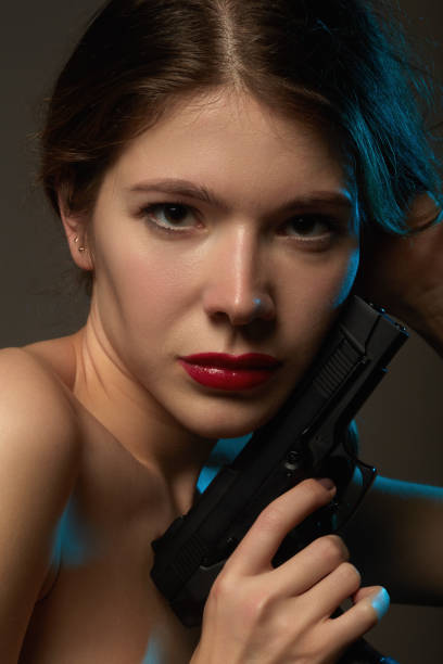istock woman with gun 1383504183