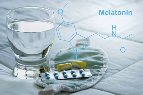 Melatonin formula, sleeping pills, earplugs, blindfold. stock photo