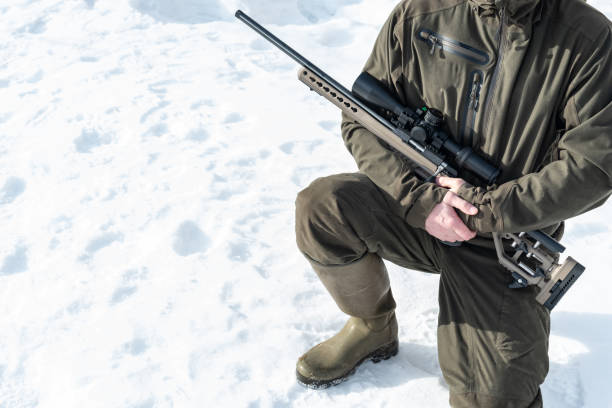 istock A sniper rifles from a rifle with an optical sight in man`s hands winter day 1383505461