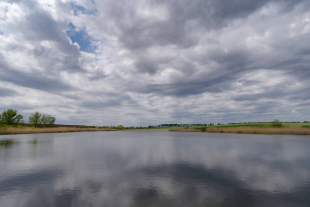 istock Scenic view of pond against sky 1383510041