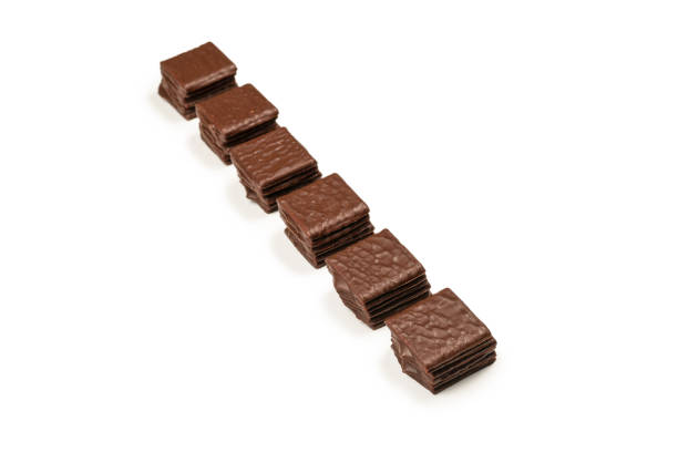 istock Dark chocolate candies isolated on white background. 1383510311