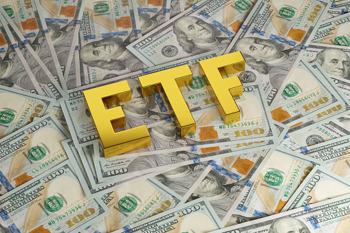 ETF solid word on dollar bills. 3d illustration.