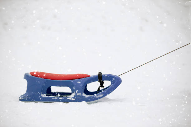 istock Snow sled on a snowy background. 1383510553