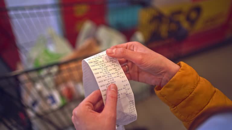 Woman hands holding paper receipt