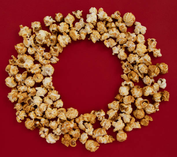 istock caramel popcorn on red background, sweet snacks 1383511756