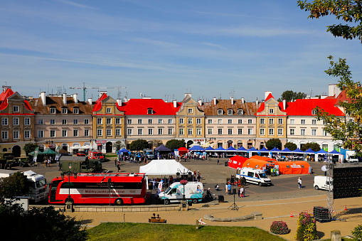Lublin, Poland - September 11, 2021: Tenement houses in the old town, in front of which there is a city square, where the rescue and health promotion event is now taking place.