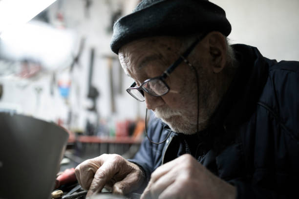 istock Real 90 plus years man at working on electronic circuit 1383514073