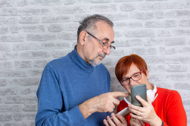 istock Happy senior couple using mobile phone 1383515428