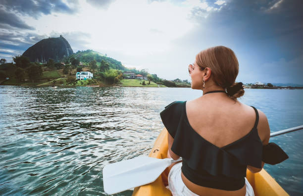 Latina woman traveling in a kayak stock photo