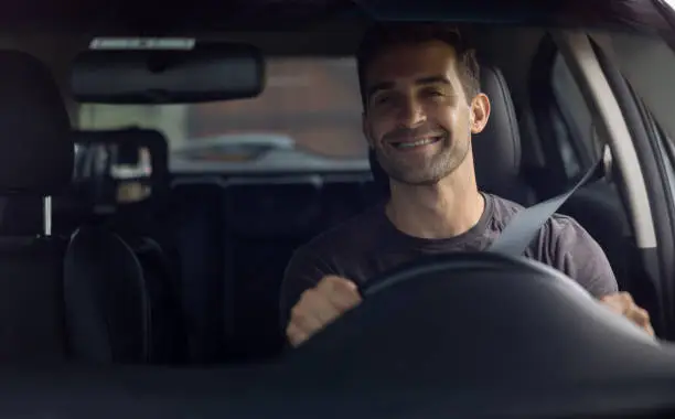 Photo of Happy man driving a car