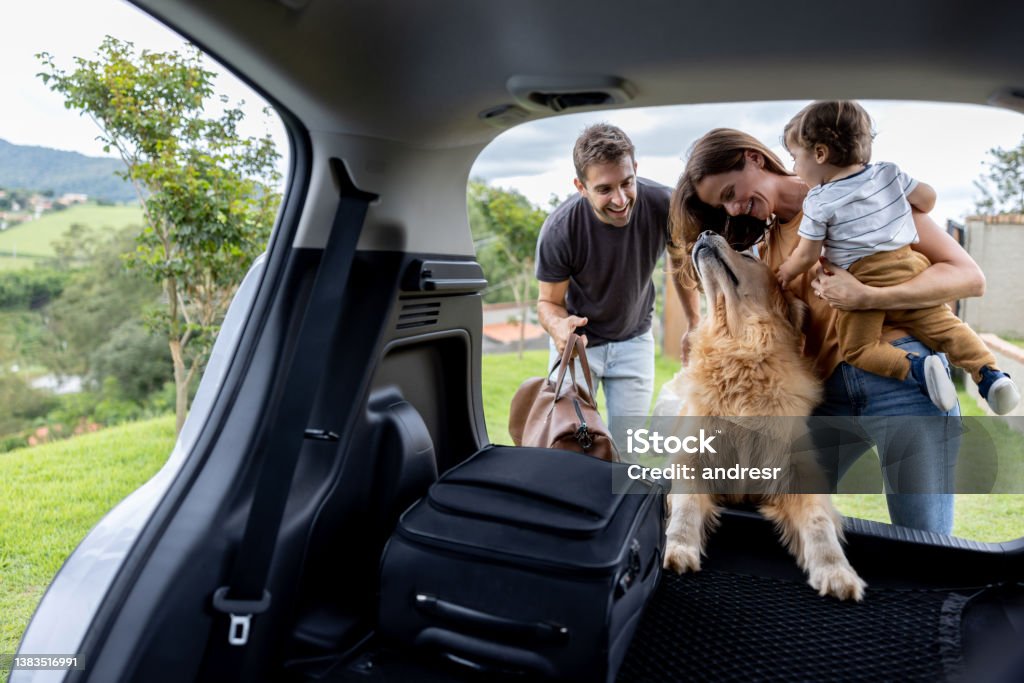 Happy family loading bags in the car and going on a road trip Happy Brazilian family loading bags in the car and going on a road trip - travel concepts Family Stock Photo