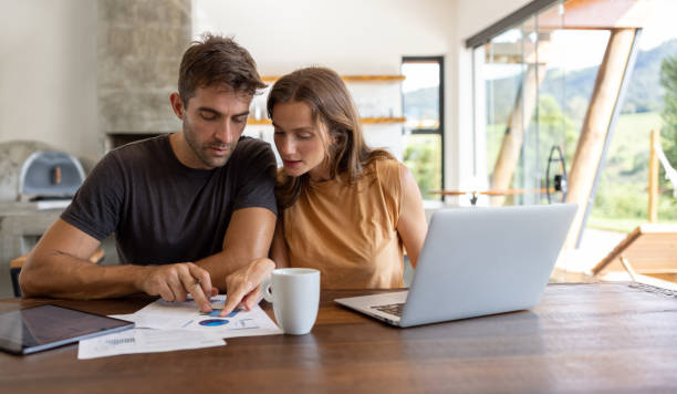 istock Couple checking their home finances and paying bills online 1383517068