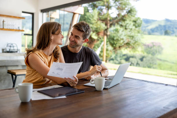 istock Loving couple paying bills online at home 1383517079