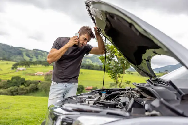 Photo of Man calling his car insurance after having a vehicle breakdown on the road