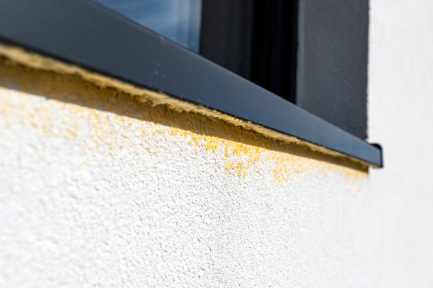 istock Yellow mounting foam filled under the window sill, white plaster is stained by sloppy work. 1383517103