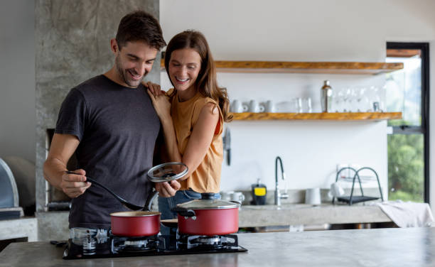 istock Man cooking dinner at home for his wife 1383518867