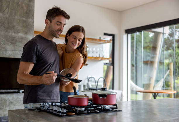 istock Happy man cooking dinner for two at home 1383518888